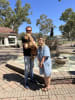 Louis visiting the Dog on the Tuckerbox Kiosk and Farm Shop and monument with their human parents.