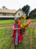 Author Mavis Kerinaiua at the Old Church precinct on Bathurst Island. The vase Mavis is holding is an empty Japanese bombshell and as a goodwill gesture, she says she has 'flowers instead of fireworks' shooting out of it. Photo by Allen Murphy. 