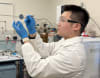 Dr Kaiqiang He holds the new atomically thin membrane designed to supercharge the next generation of hydrogen fuel cells.