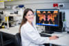 Study co-lead Dr Clare Weeden inspecting confocal microscope image of lung cell colony grown in the laboratory from a single lung stem cell from a cancer patient.