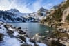 Gerber Lake, surrounded by snow-covered mountains in Aigüestortes National Park. 