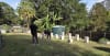 Homes and Granny Flats representatives inspect the prepared site at the Bowley family's Sunshine Coast property ahead of the delivery and installation of the donated portable home.
