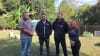 The Bowley family with representatives from Homes and Granny Flats after learning they would receive a fully donated portable home following their $42,000 loss.