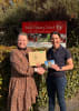 Auburn Primary School principal Skye Irwin receiving a George the Farmer book pack from Rabo Client Council member Claire Catford.