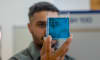 Dr Jordan Noronha holding a sample of the floating titanium.