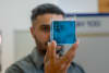 Dr Jordan Noronha holding a sample of the floating titanium. Credit: Sara Tan, RMIT.