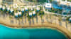 Aerial view of Jayasom Wellness Resort AMAALA, capturing the resort's beachfront location on Triple Bay and its surrounding natural beauty.
