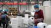 Workers are packaging paper products.