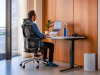 Side view of a man seated upright in a Sihoo Vito M90 at a desk