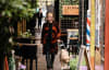A woman walks through the street with her Seeing Eye Dog