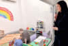 UNSW Professor Eva Kimonis stands behind a one-way mirror to coach a parent interacting with their child.