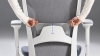 A hand adjusting the lumbar pad on the backrest of a SIDIZ T50 2nd Generation ergonomic office chair. 