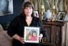 Rebekah Porter - holding photo of Biddy Porter with Biddy's Urn in the background