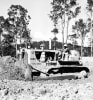 Thiess1.jpg: A Thiess Bros employee on the company's first D8 tractor in 1939 - Cat's powerful machines enabled Thiess Bros to take on larger and more complex jobs