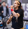 Yaraan Bundle-Couzens, painted up and holding clap sticks sings at a rally against seismic blasting, Sep 2023