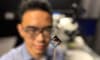 RMIT PhD scholar and study first author Thiha Aung inspects the team's neuromorphic vision device. Credit: Will Wright, RMIT University