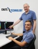 Chute Technology Principal Engineer Dennis Pomfret (standing) and Senior Mechanical Engineer Gian Naldi (seated) look to the future as the company celebrates a decade of materials handling problem solving.