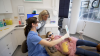 Dr Monica Farrelly with a young patient and her mum