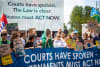 Youth leaders and frontline communities demonstrate in front of the Peace Palace, the seat of The International Court of Justice.