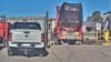 Truck at the Cobra Group's premises carrying full skip bins driving over a weighbridge which is not recording.