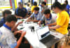 Students from Dripstone Middle School in Darwin work with the teacher and a Makerbus educator to build and program dancing robots. Photo: UNSW