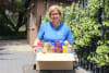 St Vincent de Paul Society Canberra/Goulburn volunteer member providing an emergency food hamper.