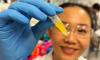 Dr Dao Nguyen examines a vial of lutein formulation developed for potential use in eyedrop treatments. Credit: Will Wright, RMIT University
