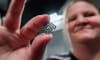 Professor Kate Fox from RMIT's School of Engineering holds a spiral-shaped prototype of the diamond-titanium implantable device. Credit: Shu Shu Zheng, RMIT University
