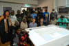 Sam Williams and Rohan Fisher (centre) with Maningrida Elders who supported the map. The model combines 3D technology and video to create an interactive map filled with traditional knowledge and stories. Credit: David Mason