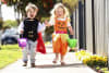 Harper and Harvey trick-or-treating with Coles Halloween pails