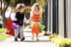 Harvey and Harper trick-or-treating with Coles Halloween pails
